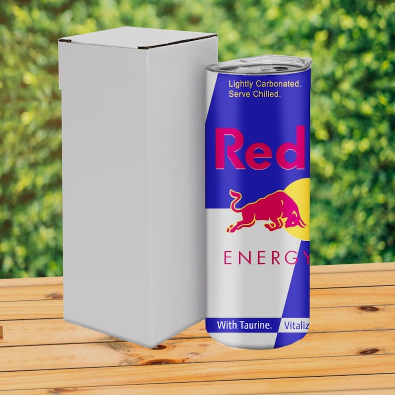 May include: A blue and white can with a red bull logo and the text "Red Bull Energy Drink" and "Lightly Carbonated. Serve Chilled."  The can also has the text "With Taurine. Vitalizes."