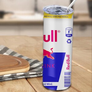 May include: A white stainless steel tumbler with a Red Bull can design. The tumbler features the Red Bull logo, a red bull, and the text "Red Bull gives you wings." and "Energy 100%".