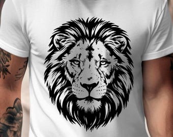 May include: White t-shirt featuring a detailed black and white lion's head graphic. The lion's mane and facial features are intricately designed. The shirt is a classic crew neck style.