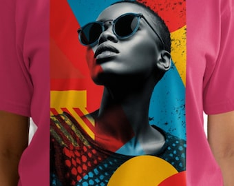 May include: A magenta t-shirt featuring a colorful graphic of a person wearing sunglasses. The graphic has a modern art style with red, blue, and yellow shapes. The person in the graphic has short hair.