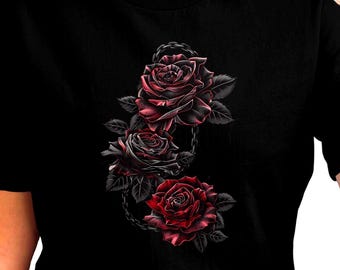 May include: Black t-shirt with a detailed illustration of three roses in shades of red and black. The roses are linked by a chain design. The shirt has a classic crew neck.