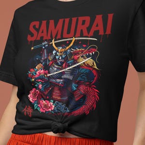 May include: Black t-shirt with a graphic of a samurai warrior and a red dragon. The word "SAMURAI" is printed in red across the top. The design includes swords, flowers, and Japanese characters.