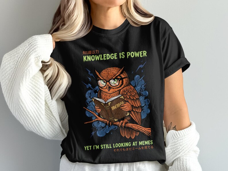 Owl wearing glasses reads a book on a branch, "Knowledge is Power."
