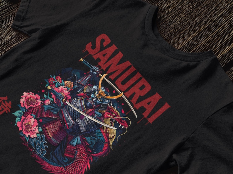May include: Black t-shirt featuring a detailed illustration of a samurai warrior riding a dragon, with swords and floral elements. The word "SAMURAI" is printed in red across the top.