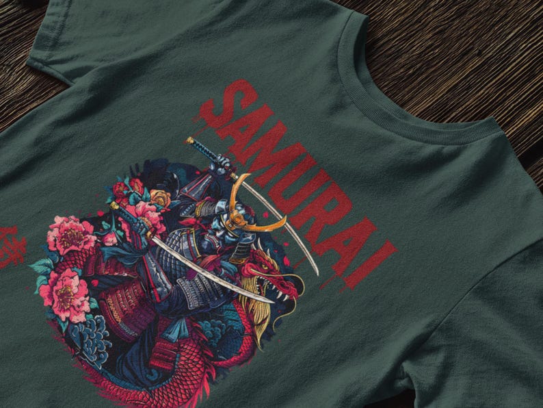 May include: Dark green t-shirt featuring a detailed illustration of a samurai warrior with two swords, riding a red dragon. The word "SAMURAI" is printed in red across the top. Pink and blue flowers surround the warrior and dragon.