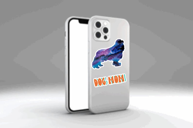 May include: A white iPhone case with a galaxy-themed dog silhouette and the text "DOG MOM" in orange and green.