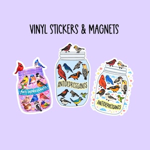 May include: A set of three ceramic mugs with a speckled, matte finish. The mugs are in shades of cream, light gray, and dark gray. Each mug has a simple, minimalist design and a rounded handle.