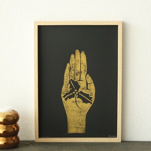Christmas Linocut print: golden hand with leaf on black