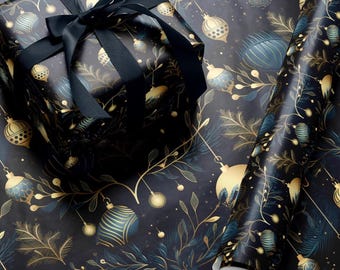 May include: Black and gold wrapping paper with a repeating pattern of stylized ornaments and leaves. The paper is rolled up and a black gift box with a black ribbon is on top of the roll.