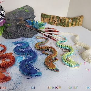 May include: A collection of colorful, articulated dragon figurines in various colors: fire, ice, rainbow, candy, and ghost (glow). The dragons are displayed on a white surface with decorative elements. The text "AUTHORIZED SELLER" is in a circular badge.