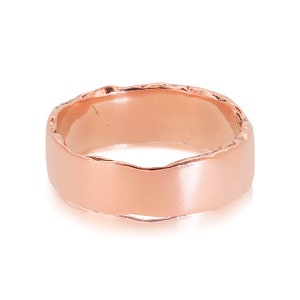 9ct rose gold Dart Wedding ring measuring 6.5mm wide by 1.4 mm deep on its side to show the smooth face and textured edge. The widest band in our collection.