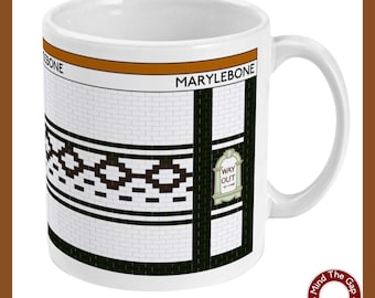 May include: White ceramic mug with a black and white tiled design featuring the words "Marylebone" and "Way Out".
