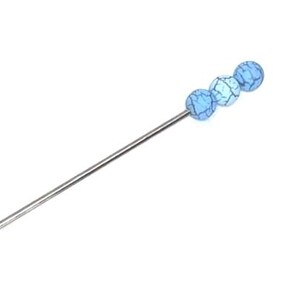 May include: A long, slender metal hair pin featuring a decorative end adorned with three small, round, light blue beads. The pin has a sharp, pointed tip at one end and a smooth, straight shaft, providing a simple and functional design for securing hair.