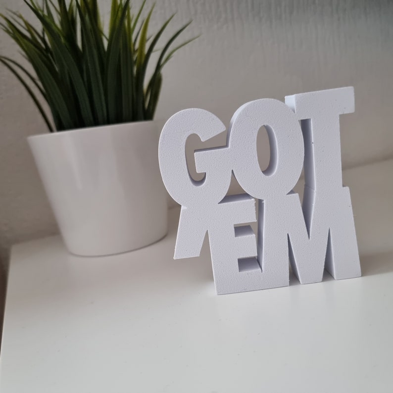 May include: White wooden sign with the words "GOT 'EM" in bold, block letters.