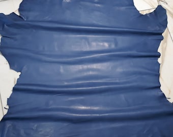 May include: A piece of blue leather with a smooth, slightly shiny finish. The leather is folded and has a few wrinkles.