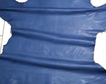 May include: A large piece of blue leather with a smooth, slightly shiny finish. The leather is folded and has a few wrinkles.