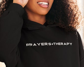May include: Black hooded sweatshirt with the text "PRAYERS+THERAPY" in white lettering.