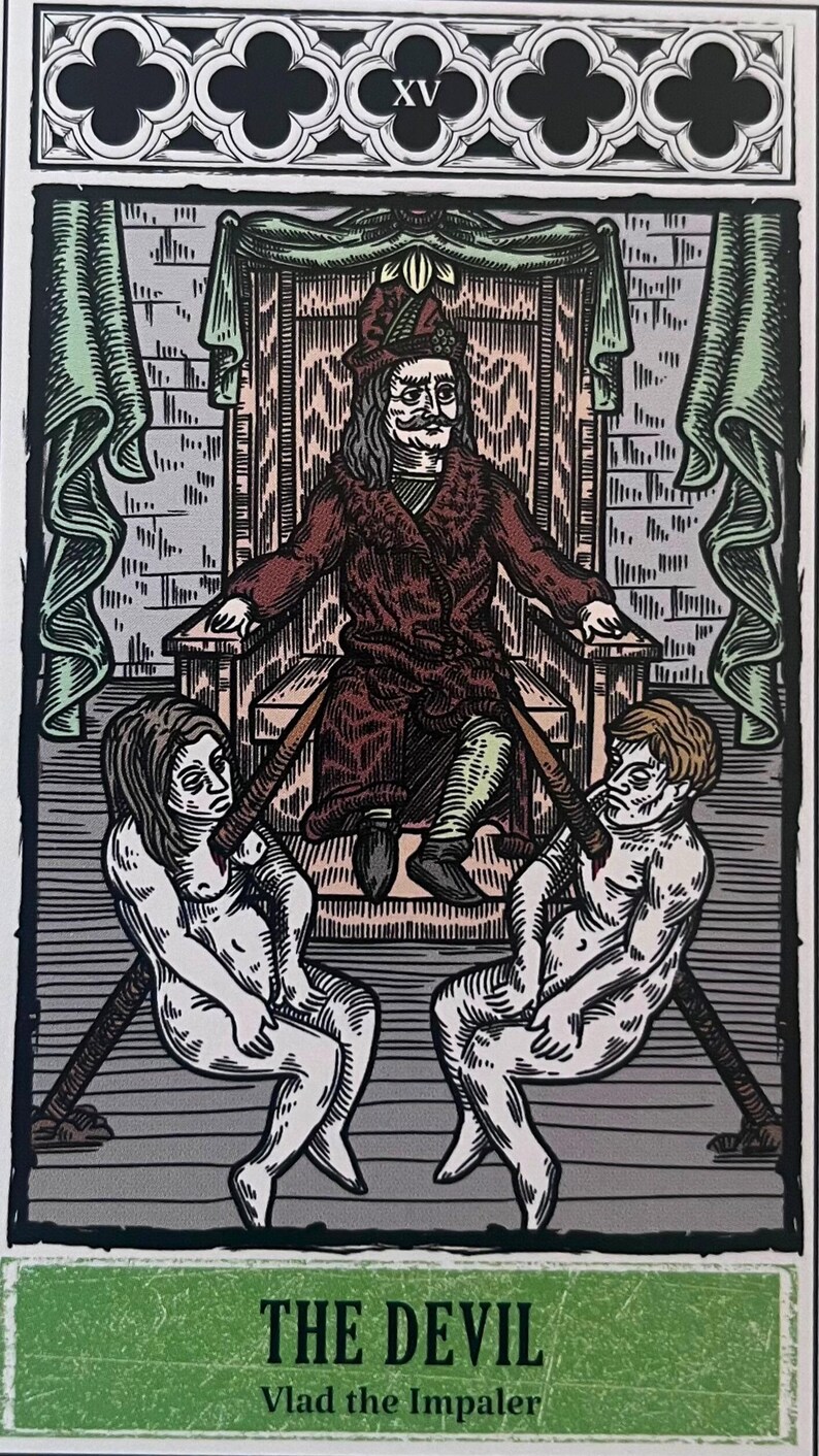 May include: A tarot card depicting the Devil, the XV card in the deck. The card features a red-robed figure sitting on a throne with two nude figures chained to the throne. The text "THE DEVIL" and "Vlad the Impaler" is printed at the bottom of the card.