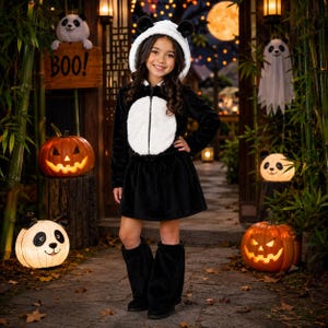 May include: A black and white panda-themed costume featuring a hooded jacket with plush ears, a white circular belly patch, a flared skirt, and matching black leg warmers. The soft, fuzzy material mimics a panda's fur, creating a cohesive look.