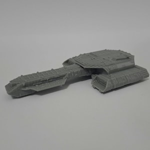 May include: A gray, detailed model of a spaceship with a long, rectangular body and multiple textured sections. The model has a complex design with various panels and ridges, suggesting a futuristic or science fiction theme.