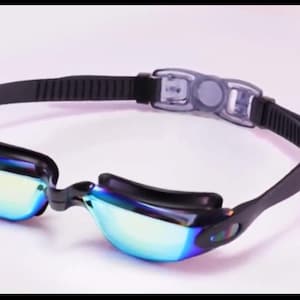 May include: Black swimming goggles with a blue and iridescent mirrored lens. The goggles have an adjustable strap and a nose bridge.