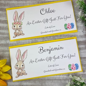 May include: Two Easter gift cards with yellow borders. Each card features a watercolor illustration of a bunny and the text "Chloe" and "Benjamin". The cards read "An Easter Gift Just For You!" and "Lots of Love, Grandad and Grandma xx".