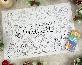 May include: A black and white Christmas-themed colouring page with the name "DARCiE" and festive illustrations. Includes a Christmas tree, snowman, elf, and a box of four crayons with bright assorted colours.