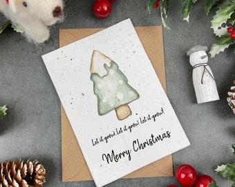 May include: A Christmas card with a watercolor illustration of a green Christmas tree with white dots. The card is made of seed paper and has the text "Let it grow. Let it grow. Let it grow! Merry Christmas" printed on it.