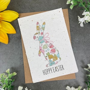 May include: A white card with a floral patterned bunny silhouette and the text "Hoppy Easter". The card is on a brown envelope.