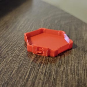 May include: A bright red hexagonal plastic container with a smooth, flat interior.