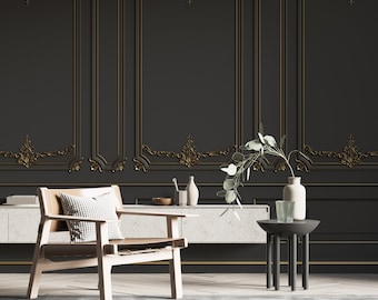May include: A light brown leather armchair with a white and black checkered cushion sits in front of a black wall with gold trim. A small black side table with a vase of green leaves and a glass sits next to the chair.