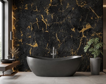 May include: A matte charcoal gray freestanding bathtub positioned in front of a black marble wall with gold veining. A silver faucet stands behind the tub. To the left, a wooden vanity holds a dark bowl sink, and a potted plant sits to the right.
