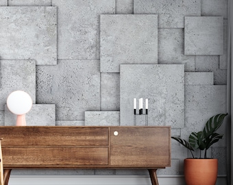 May include: A wooden dresser with two drawers and a cabinet door. The dresser has a light wood finish and sits on six legs. The dresser is in front of a wall with a concrete tile pattern. There is a small lamp and a candle holder on top of the dresser.