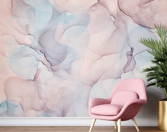 May include: A pink armchair with wooden legs sits in front of a wall with an abstract watercolor design in shades of pink, blue, and purple.