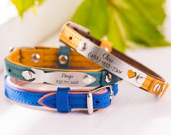 May include: Three leather dog collars with personalized metal tags. The top collar is brown with yellow stitching and has the name "Cleo" and phone number "(488)-035-7301" engraved on the tag. The middle collar is teal with yellow stitching and has the name "Diego" and phone number "835.701.3428" engraved on the tag. The bottom collar is blue with pink stitching.