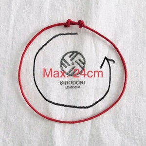 May include: A red cord forms a circle with a black outline and arrow, indicating a maximum diameter of 24cm. The text "Max. 24cm" is visible. The center features a circular logo with the text "SIRODORI LONDON".