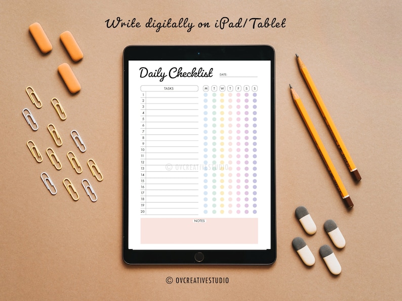 May include: A digital daily checklist on a tablet screen with a rainbow colour scheme. The checklist has 20 tasks and a section for notes. The tablet is on a brown surface with pencils, erasers, and paper clips.