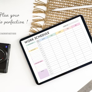 May include: A digital tablet displaying a weekly work schedule template with sections for top priority, to do list, for next week, and notes. The tablet is on a white surface with a camera and a woven mat.