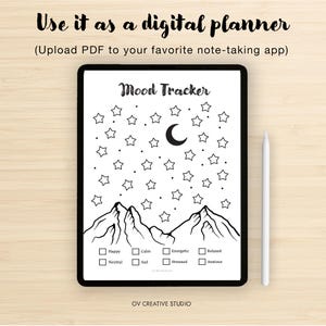 May include: A digital mood tracker on a tablet with a black border. The tracker features a mountain range, stars, and a crescent moon. Text includes "Mood Tracker" and mood options. A white stylus rests on the right. The text "Use it as a digital planner" is at the top.