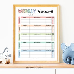 May include: A framed weekly homework planner with a wooden frame. The planner has sections for each day of the week, with spaces for subject, assignment, and due date. The text "WEEKLY Homework" is at the top in colorful letters.