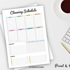 May include: A printable cleaning schedule with sections for daily, weekly, monthly, and annual tasks. The schedule is divided into days of the week and includes a calendar grid for monthly and annual tasks. The text "Print & Write" is at the bottom of the page.
