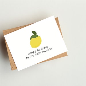 May include: A white card with a yellow lemon illustration and the text "Happy Birthday to my main squeeze".