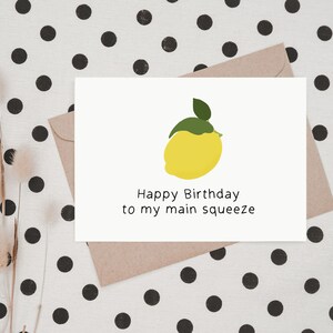 May include: A white card with a yellow lemon illustration and the text "Happy Birthday to my main squeeze".