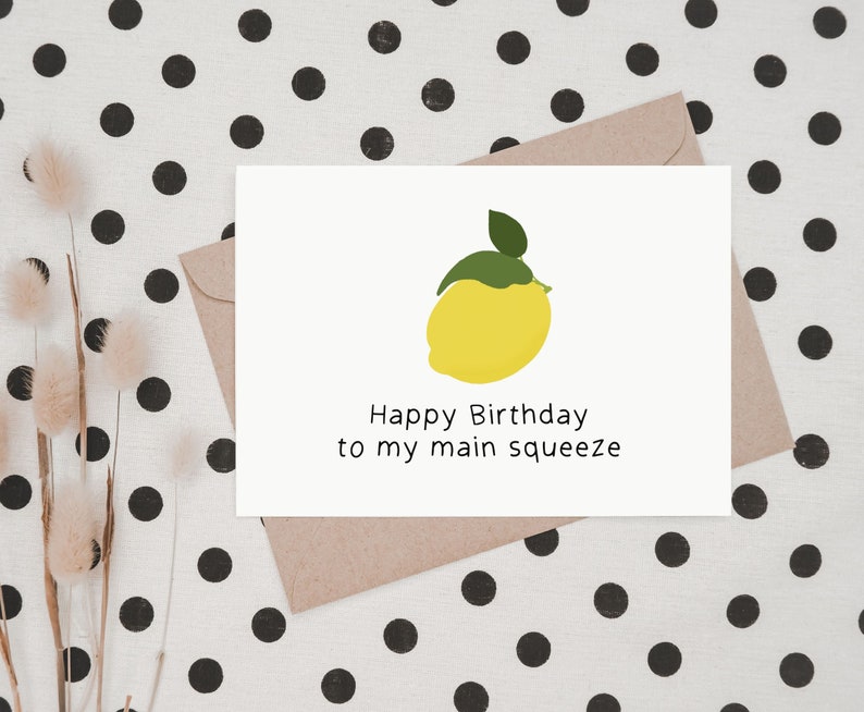 May include: A white card with a yellow lemon illustration and the text "Happy Birthday to my main squeeze".