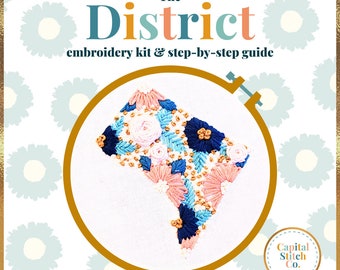 May include: Embroidery kit featuring a floral design of the District of Columbia, with the text "The District" and "embroidery kit & step-by-step guide". The kit is from Capital Stitch Co.