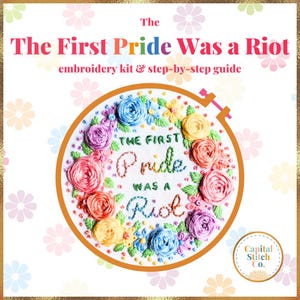 May include: Embroidery hoop with a colorful floral design and the text "The First Pride Was a Riot".