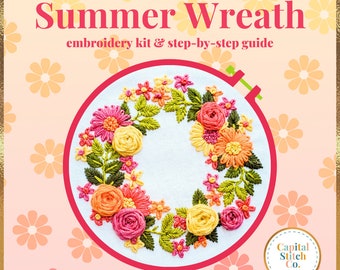 May include: Embroidery kit for a floral wreath with the text "The Summer Wreath" and "embroidery kit & step-by-step guide". The wreath is made of pink, yellow, and orange flowers and green leaves. The kit is from Capital Stitch Co.