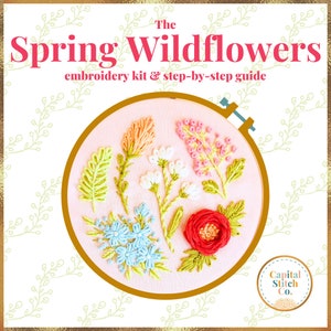 May include: Embroidery kit featuring a hoop with a pink background and colorful embroidered wildflowers. The kit includes a step-by-step guide and is titled "The Spring Wildflowers" with the logo "Capital Stitch Co."