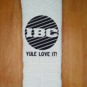 IBC TV Network Logo Yule Love It embroidered hand towels for sale by Beyond Embroidery Art. Scrooged movie Christmas classic.