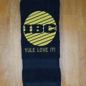 IBC TV Network Logo Yule Love It embroidered hand towels for sale by Beyond Embroidery Art. Scrooged movie Christmas classic.